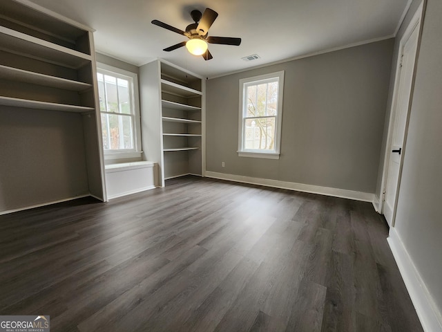 unfurnished bedroom featuring crown molding, ceiling fan, and dark wood-type flooring