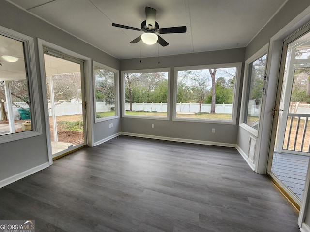 unfurnished sunroom featuring ceiling fan