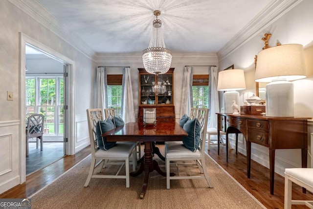 dining space with an inviting chandelier, hardwood / wood-style floors, and a healthy amount of sunlight