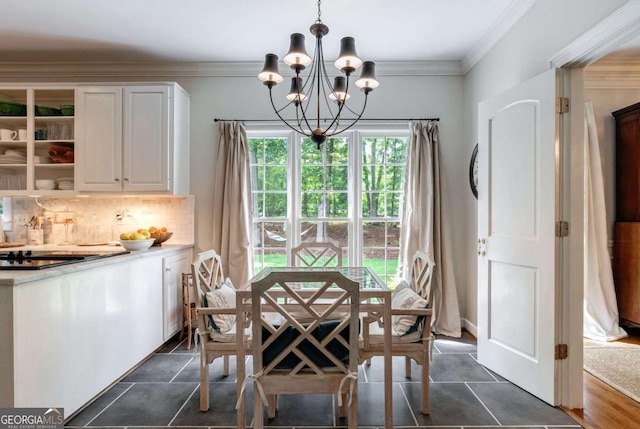 tiled dining area featuring ornamental molding and a chandelier