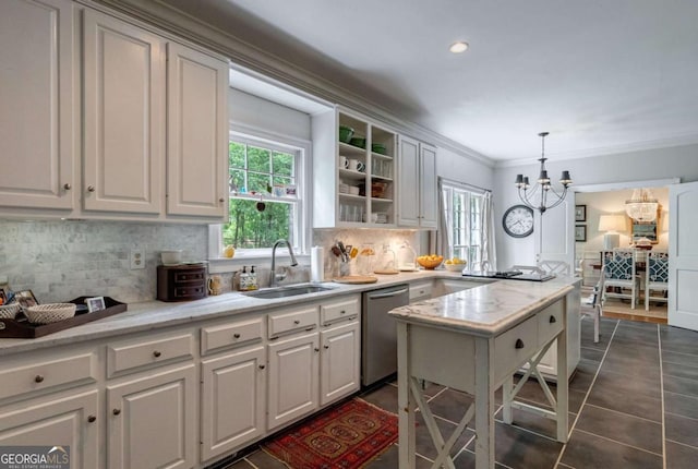 kitchen with hanging light fixtures, stainless steel dishwasher, and white cabinets