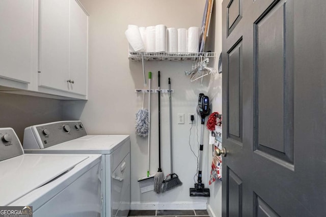 clothes washing area featuring cabinets and washing machine and clothes dryer