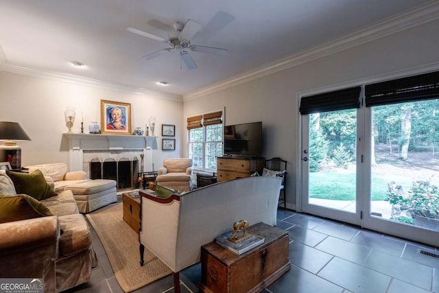 living room featuring tile patterned flooring, crown molding, and ceiling fan