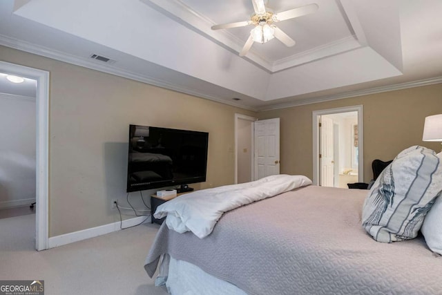 bedroom with connected bathroom, crown molding, a raised ceiling, ceiling fan, and carpet