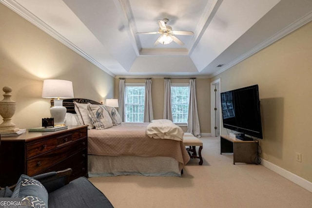 carpeted bedroom featuring crown molding, a tray ceiling, and ceiling fan