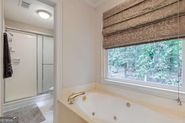 bathroom with toilet, ornamental molding, and plus walk in shower