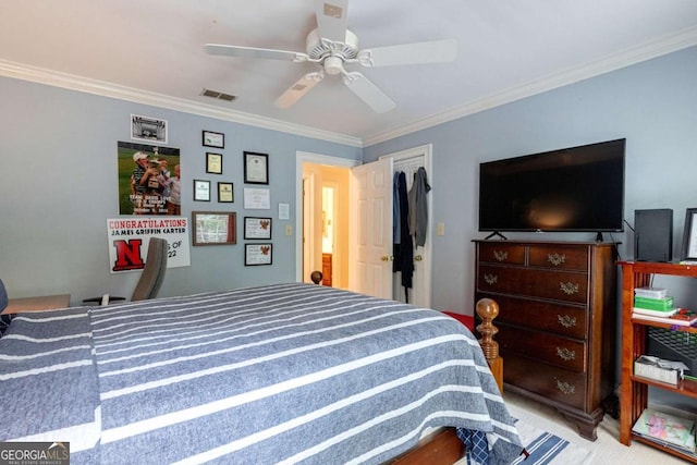 carpeted bedroom featuring ornamental molding and ceiling fan