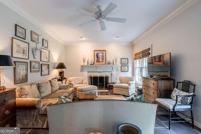 living room with ceiling fan, ornamental molding, and dark tile patterned floors