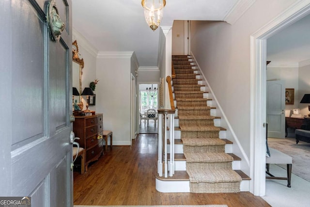 entryway with crown molding and hardwood / wood-style floors