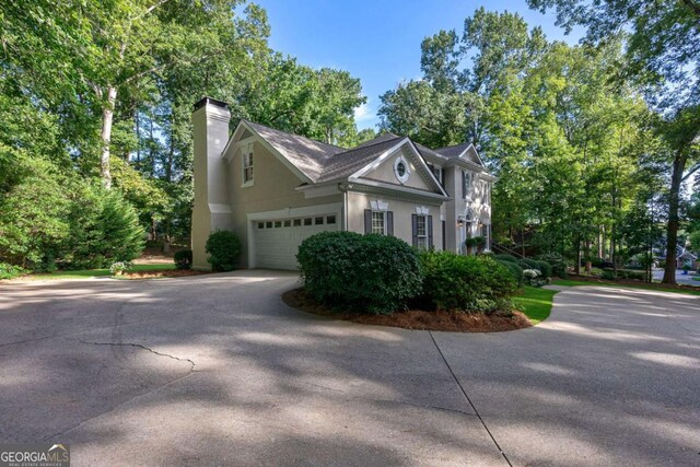 view of side of home featuring a garage