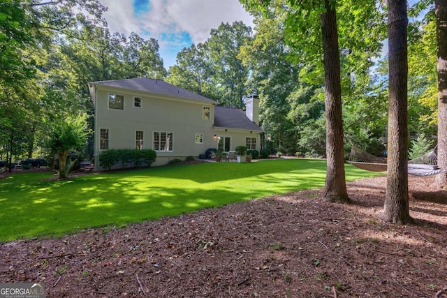 rear view of house with a lawn