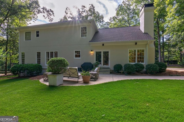 back of house featuring a yard and a patio area