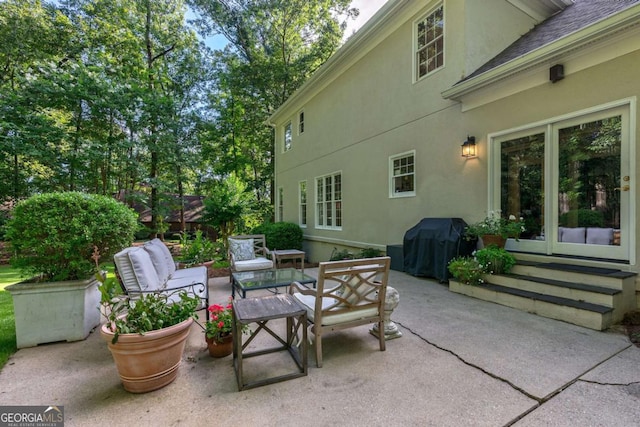 view of patio with an outdoor living space and a grill