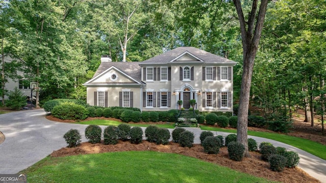 colonial-style house with a front yard