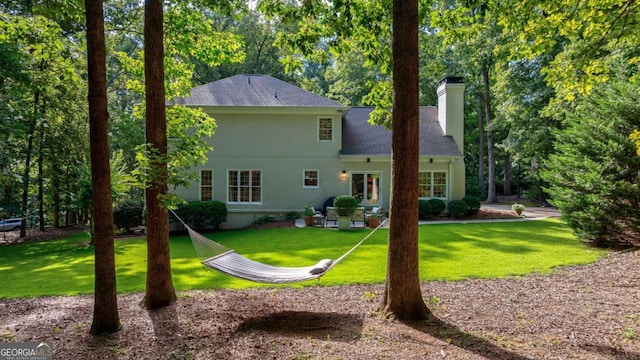 back of house with a lawn