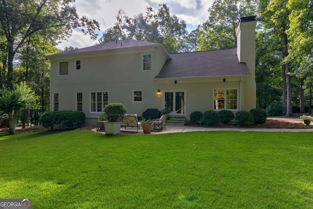 rear view of house featuring a patio and a yard