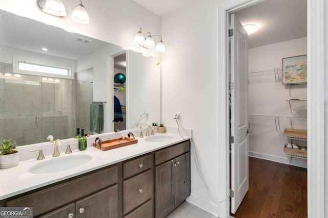 bathroom with vanity, an enclosed shower, and hardwood / wood-style floors