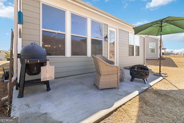 view of patio with grilling area and a fire pit