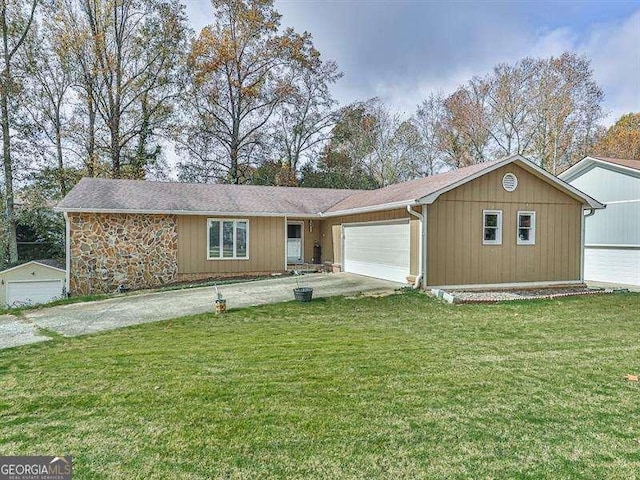 ranch-style home featuring a garage and a front yard