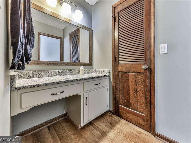 bathroom featuring vanity and hardwood / wood-style floors