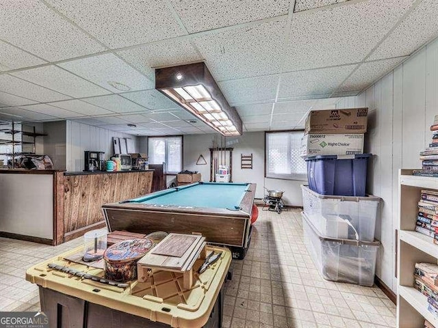 playroom featuring a paneled ceiling, pool table, and wood walls