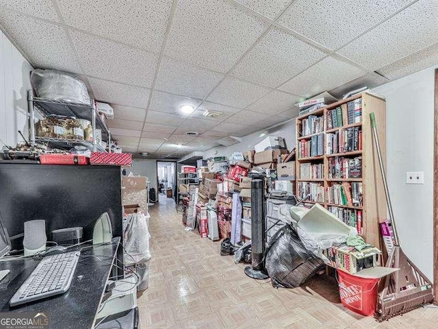 miscellaneous room with parquet flooring and a paneled ceiling