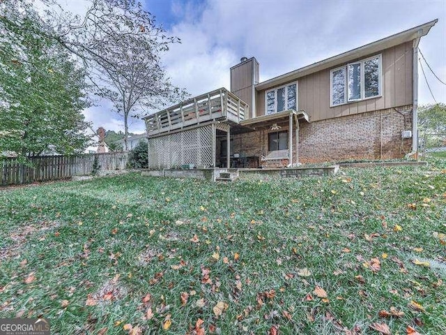 rear view of house featuring a yard