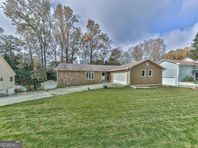 ranch-style home featuring a garage and a front yard