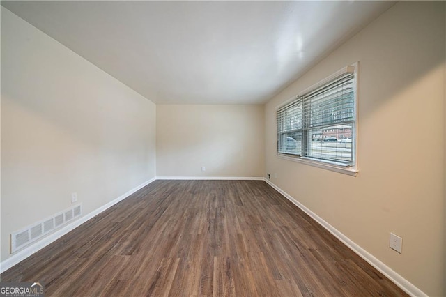 empty room featuring dark hardwood / wood-style flooring