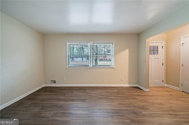 spare room with dark hardwood / wood-style flooring