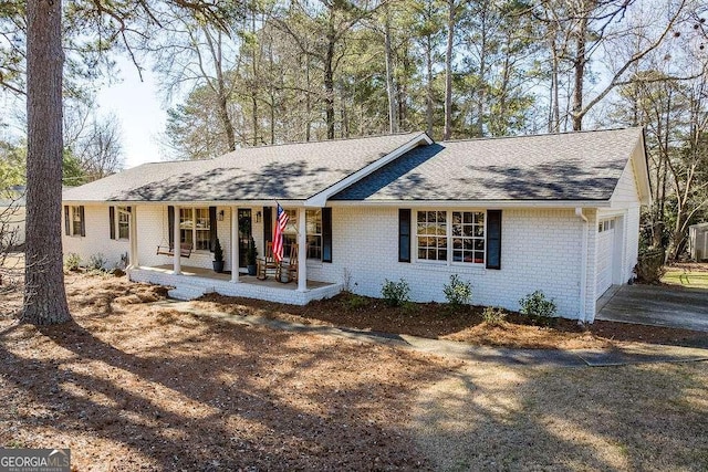 ranch-style home with a garage and covered porch