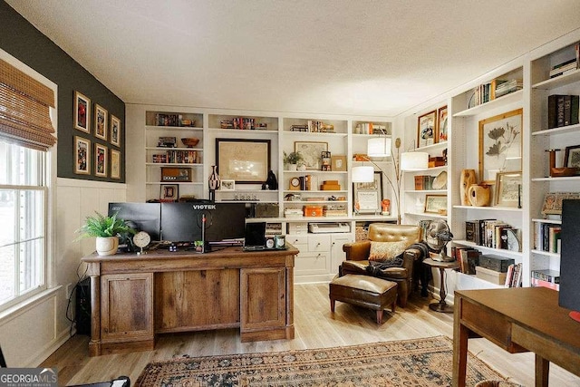 office featuring light hardwood / wood-style flooring and a textured ceiling