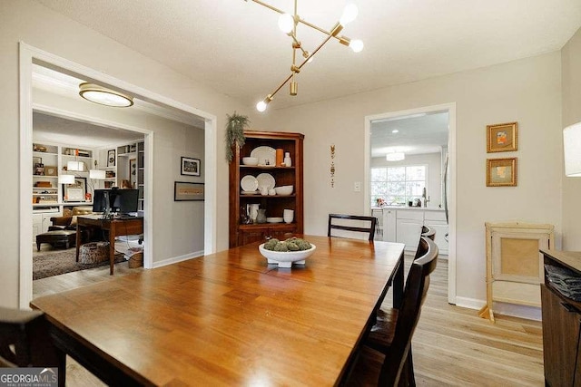 dining area featuring a chandelier and light hardwood / wood-style floors