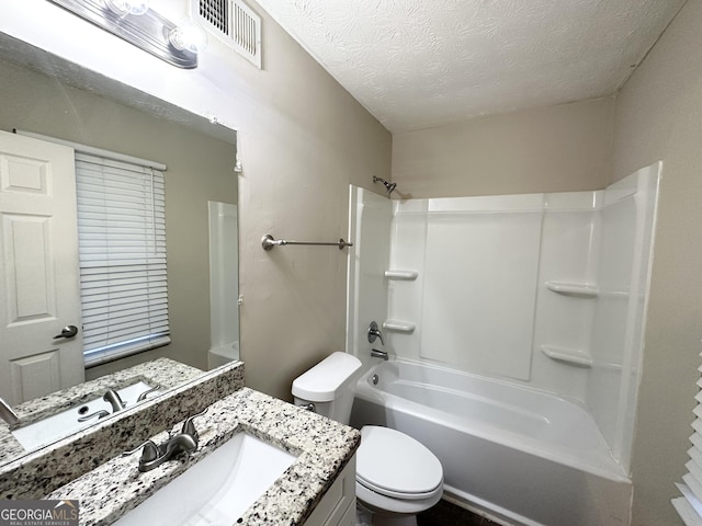 full bathroom with bathing tub / shower combination, vanity, a textured ceiling, and toilet