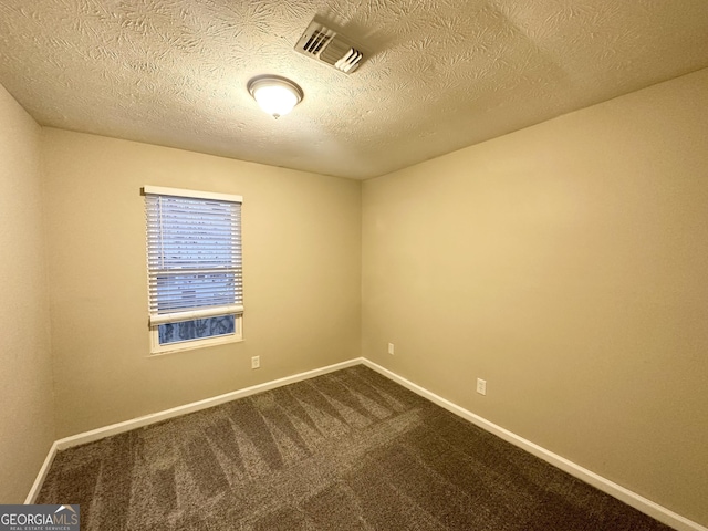 carpeted spare room featuring a textured ceiling