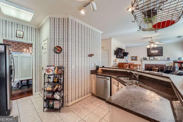 kitchen featuring light tile patterned flooring, ornamental molding, stainless steel appliances, and sink