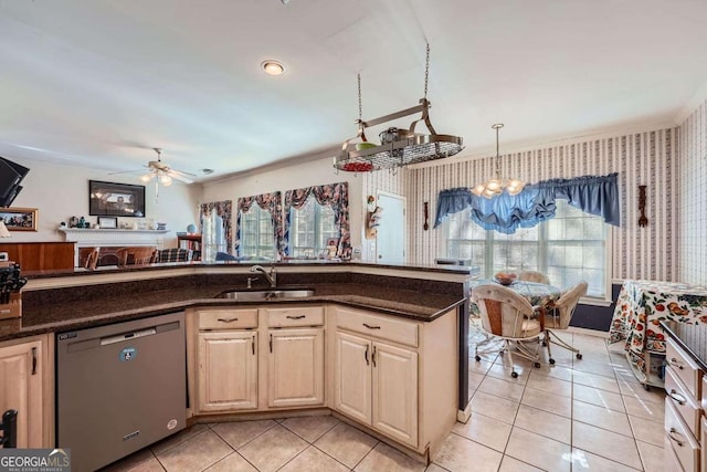 kitchen with sink, light tile patterned floors, hanging light fixtures, ceiling fan with notable chandelier, and stainless steel dishwasher