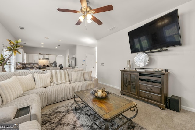 living room featuring light carpet and ceiling fan