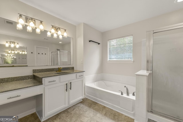 bathroom with vanity and separate shower and tub