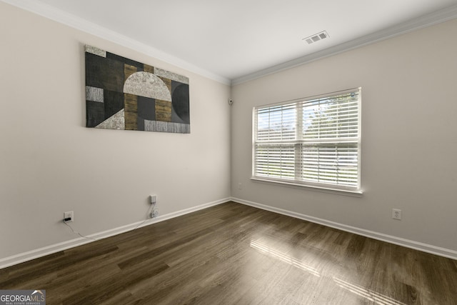 empty room with ornamental molding and dark hardwood / wood-style flooring