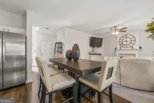 dining space with dark wood-type flooring and ceiling fan