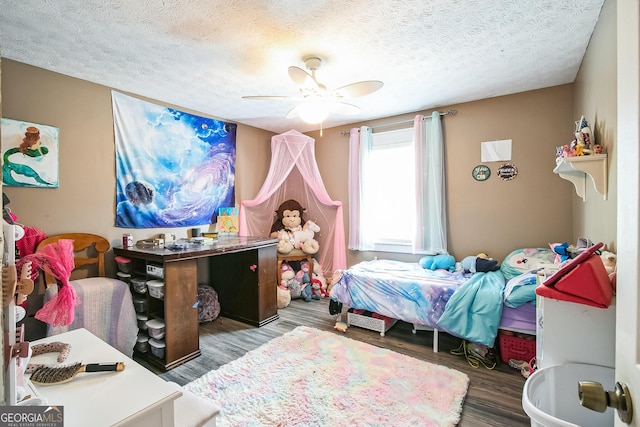 bedroom with ceiling fan, dark hardwood / wood-style flooring, and a textured ceiling