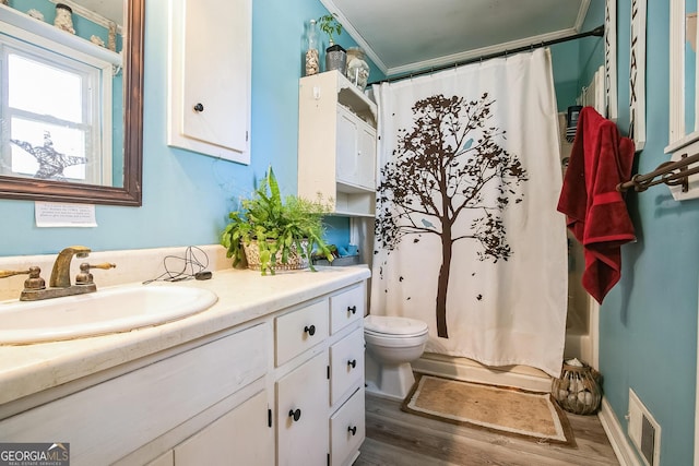 full bathroom featuring wood-type flooring, vanity, toilet, crown molding, and shower / bathtub combination with curtain