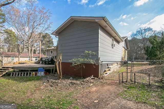 view of property exterior featuring a wooden deck