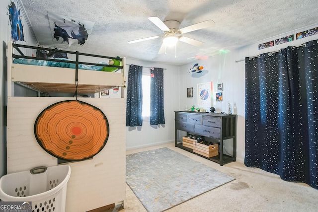 bedroom featuring ceiling fan, light carpet, and a textured ceiling