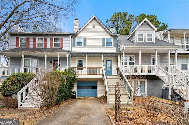 townhome / multi-family property with a porch and a garage