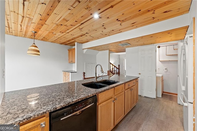 kitchen with pendant lighting, sink, dishwasher, white refrigerator, and dark stone counters