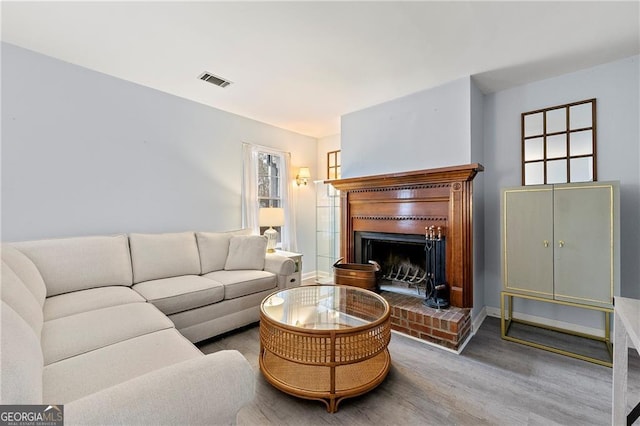 living room with hardwood / wood-style flooring and a fireplace