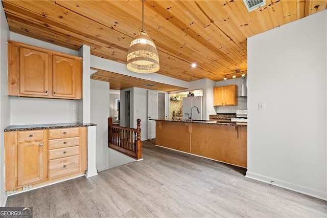 kitchen with wood ceiling, stainless steel fridge, hanging light fixtures, tasteful backsplash, and light wood-type flooring