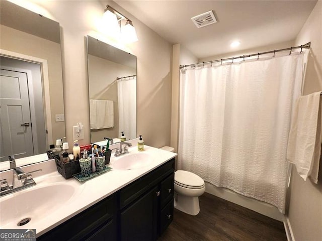 full bathroom with vanity, wood-type flooring, shower / bath combination with curtain, and toilet